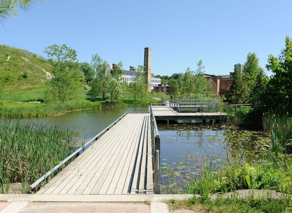a ravine terrace with elevated walkway and pond