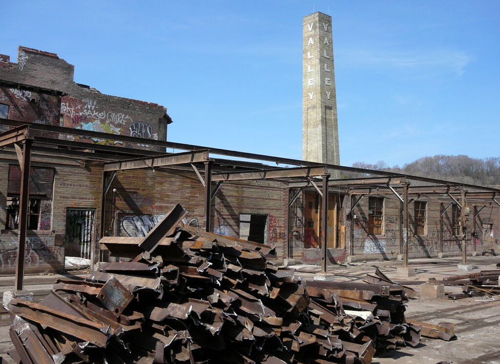 Brickworks before renovation with pile of building debris in foreground