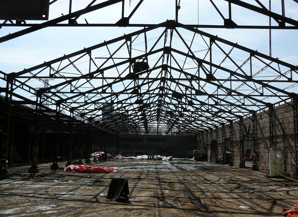 Inside abuilding with the roof removed and scaffolding exposed