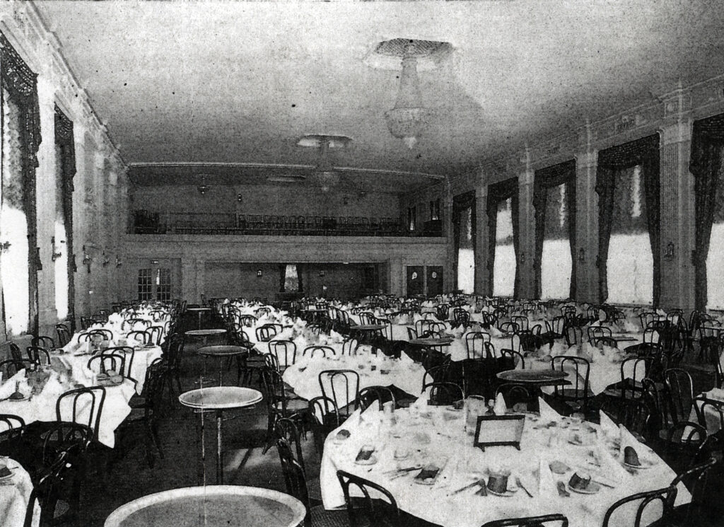 archival photo of crystal ballroom; many tables set, with chairs