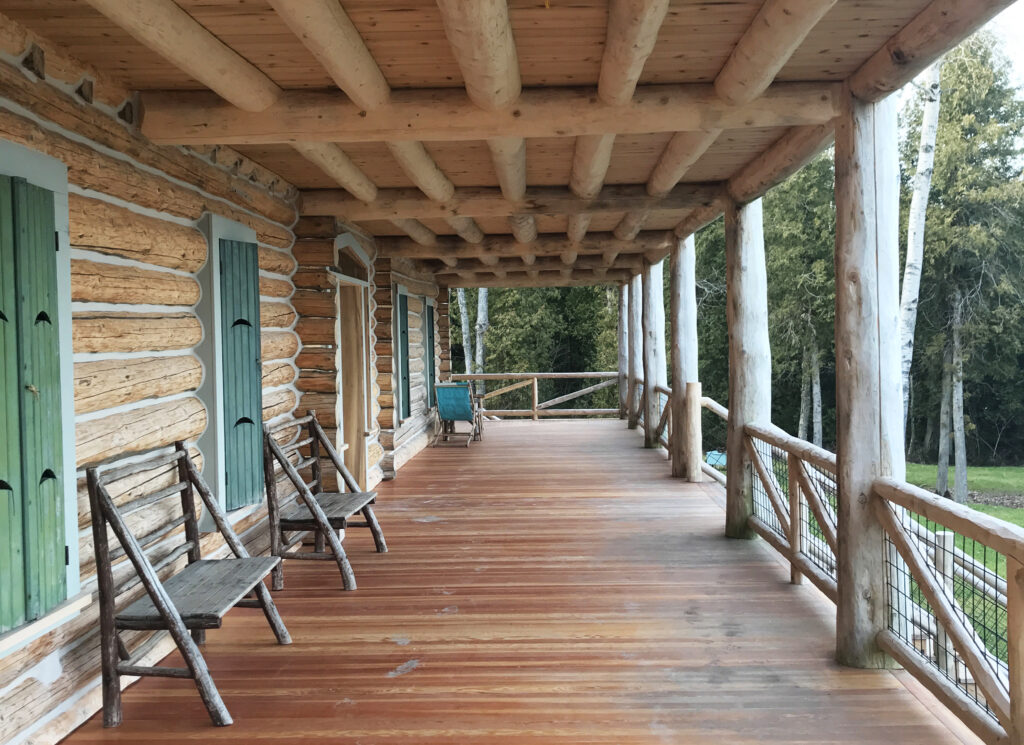 long view of the porch/balcony showcasing the wooden deck and roof structure