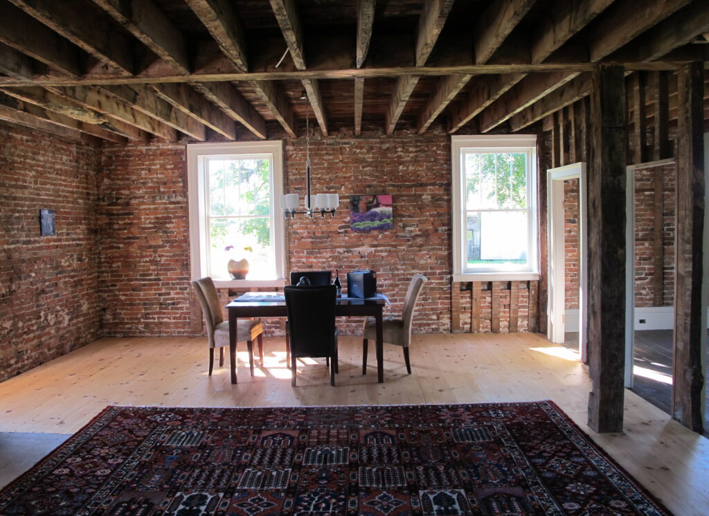 interior view showcasing exposed brick and wooden roof structure