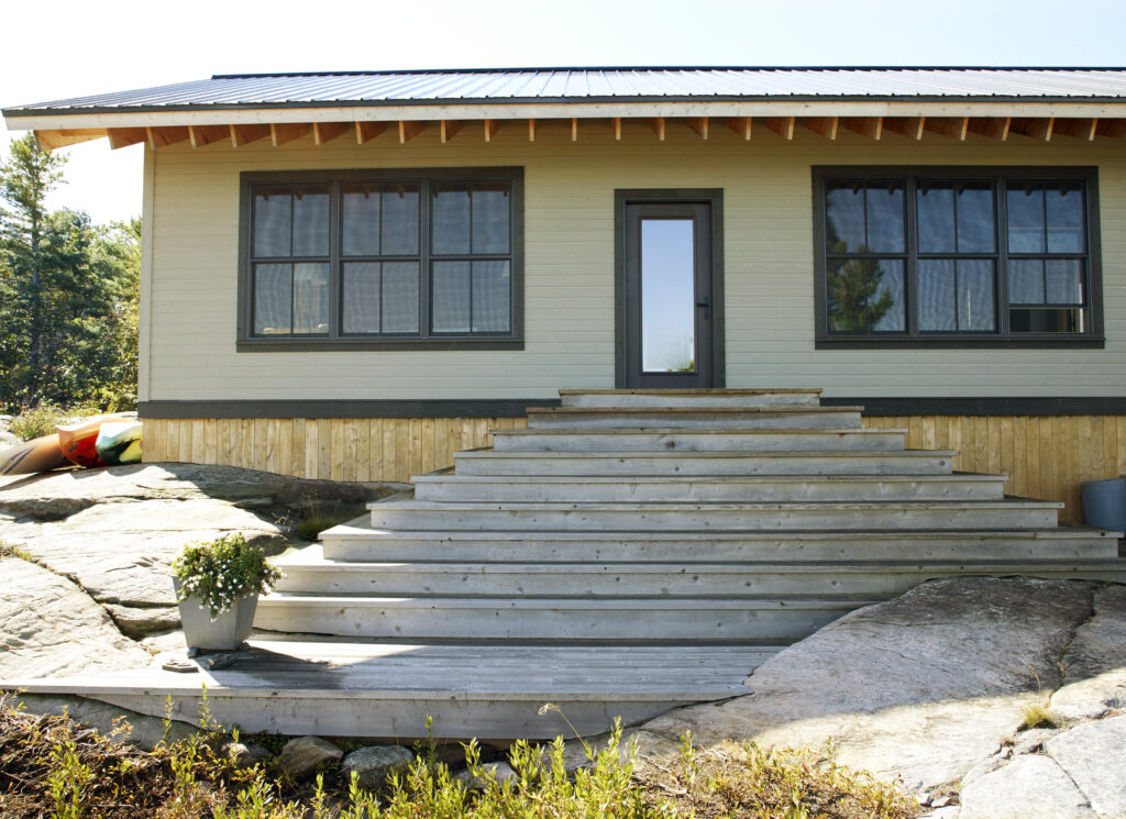 photo showing a series of steps leading from a rocky surface up to the front door of the cottage