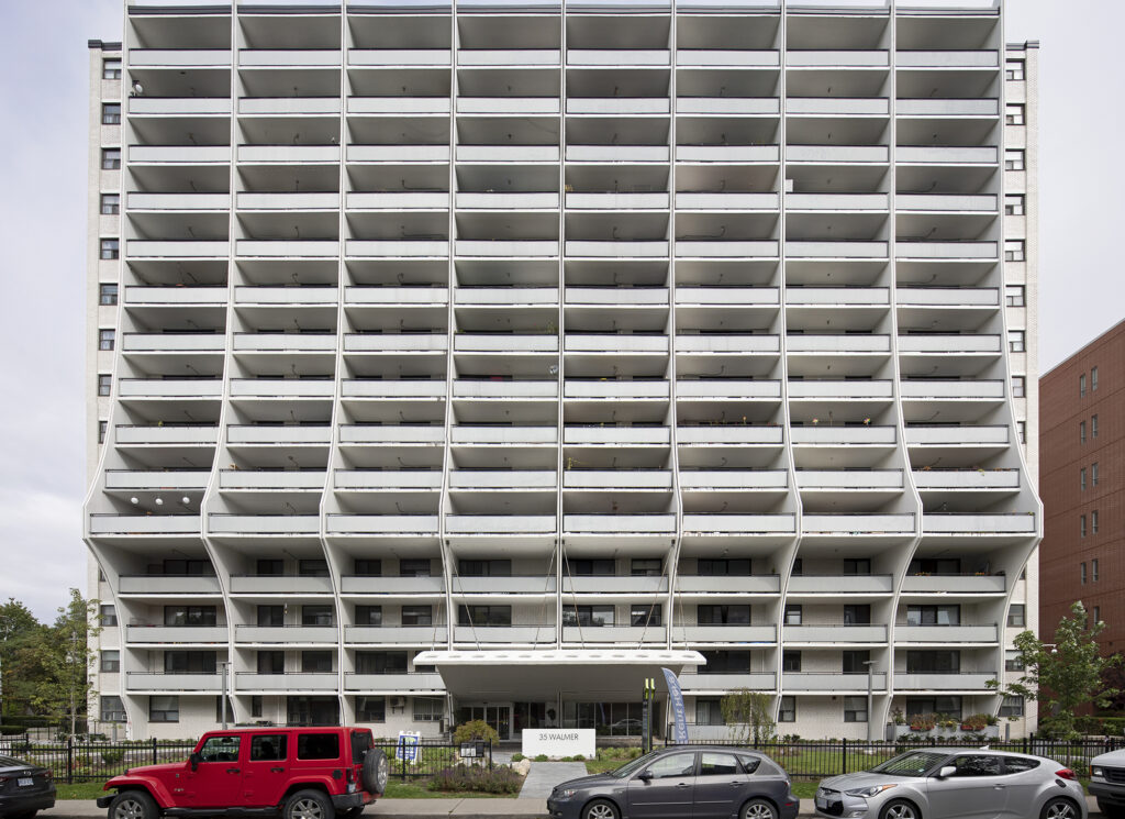 Photo of a white apartment building with balconies
