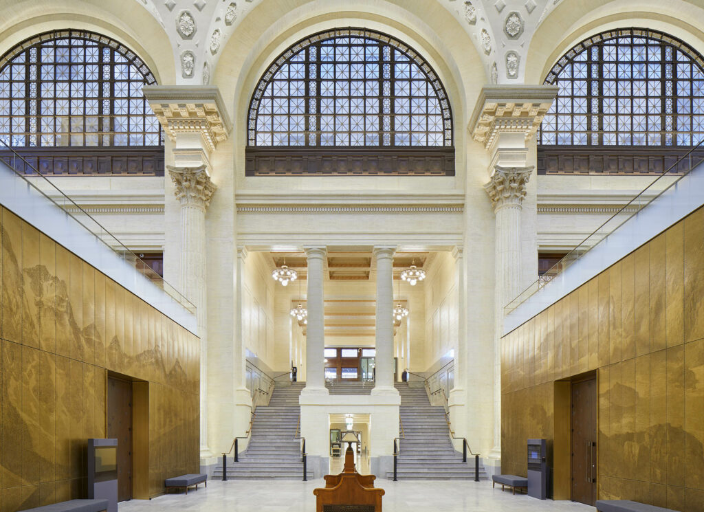 Interior of Senate of Canada Building, showing the grand hall: arched windows and plaster ceiling.