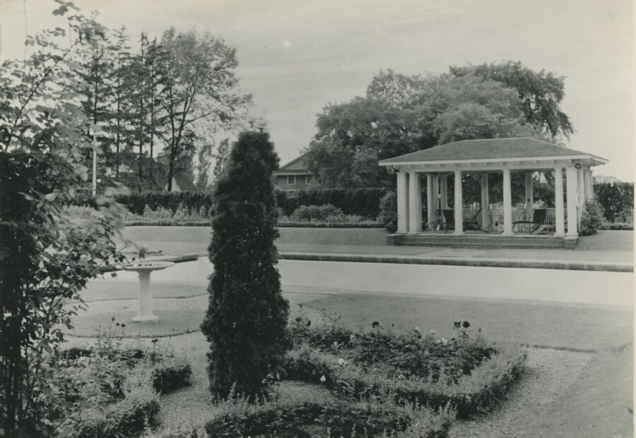 Archival photo of Rand Estate showing a tea house and manicured gardens in foreground, vast landscape behind.