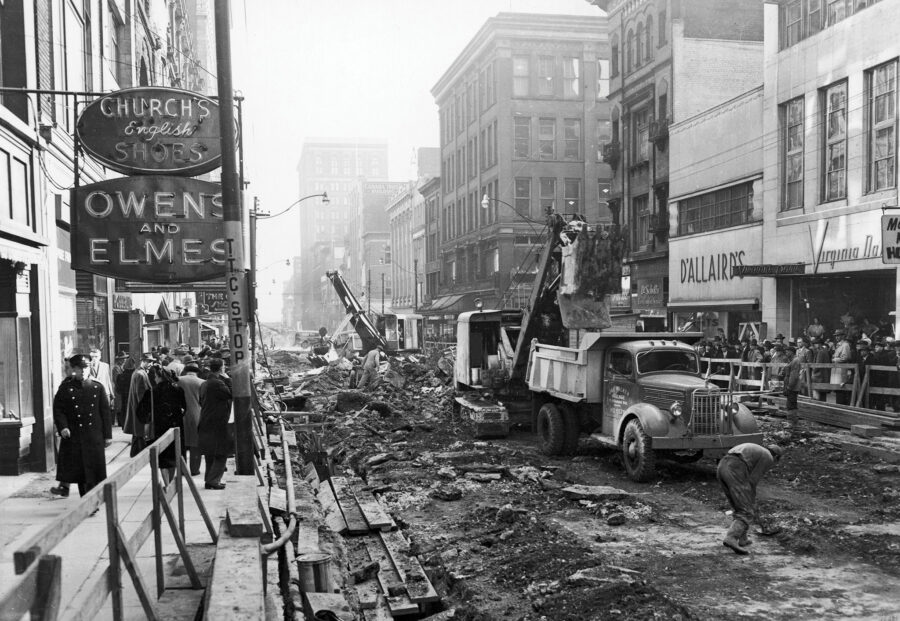 Black and white archive photo shows Yonge street under construction, equipment and machinery on the street tearing it up and preparing for further digging. 